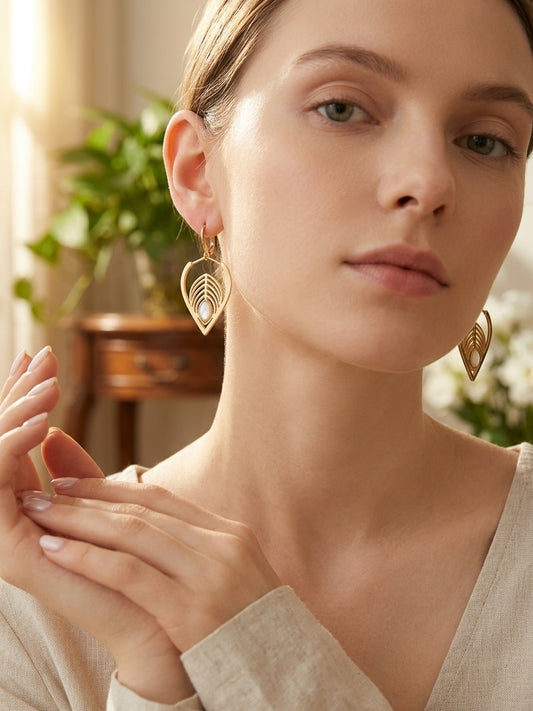 Model wearing Gold Teardrop Drop Earrings with White Oval Inlay