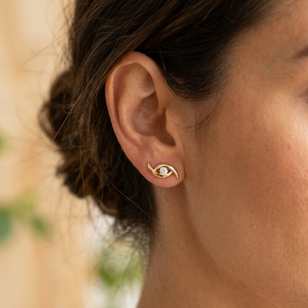 Model wearing Gold Eye Motif Stud Earrings