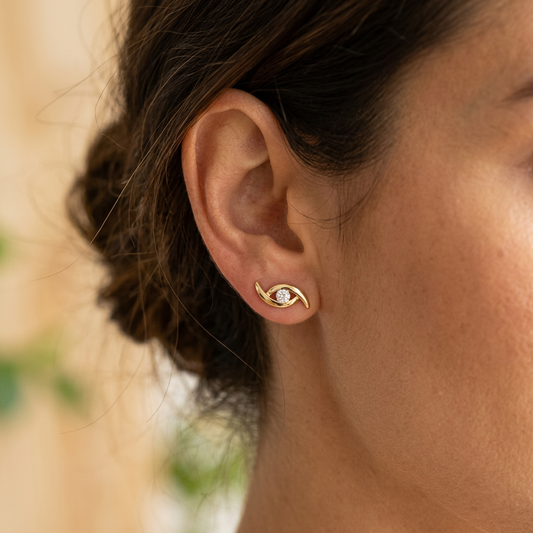 Model wearing Gold Eye Motif Stud Earrings