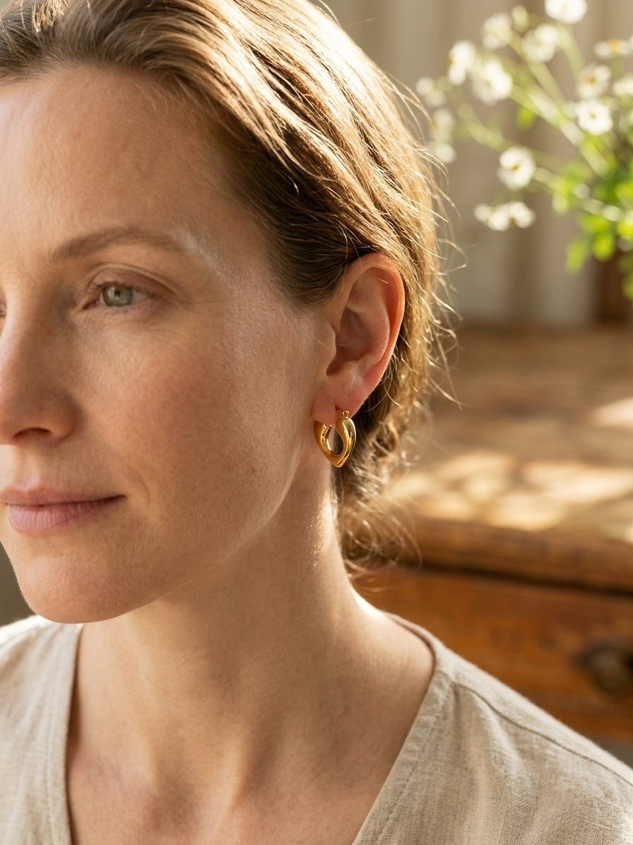 Model wearing Small Gold Heart Hoop Earrings